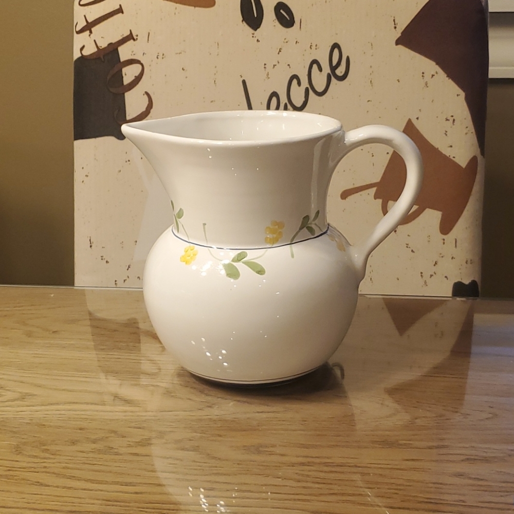 White pitcher with flower